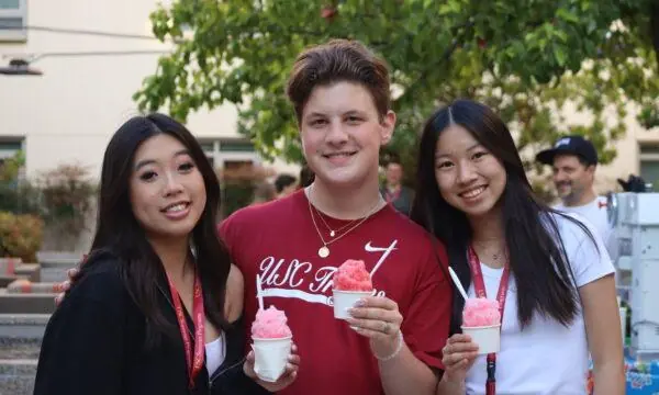 Three students in USC Summer Programs hold pink snowcones and smile at the camera. Here are some benefits of non-credit summer programs.