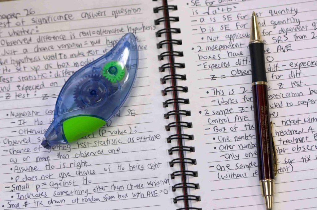 Notes from a class with correction tape and a pen. Here's how to find and apply for college scholarships.