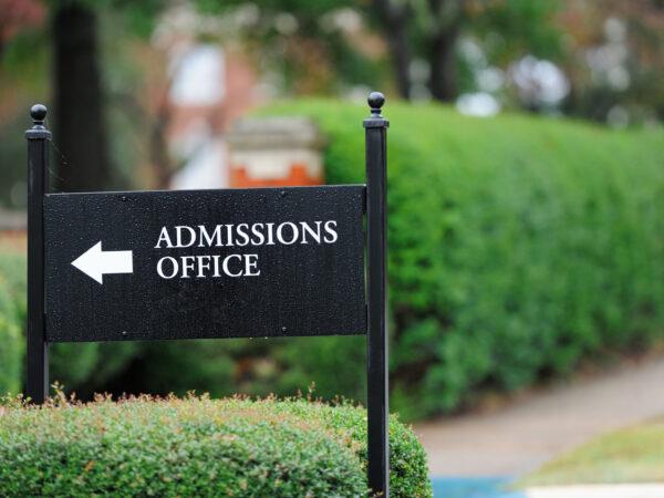 A black sign on a public university campus reads "Admissions Office." Here's how to prepare for a college admissions interview.