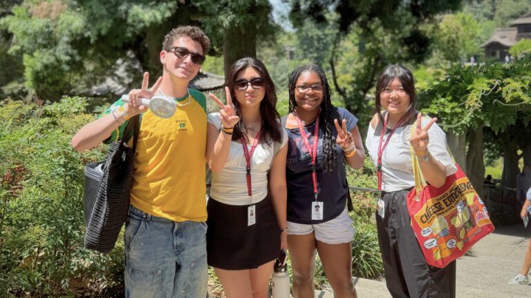 Three students in the "Creative Writing Workshop" summer program stand in the gardens of The Huntington.