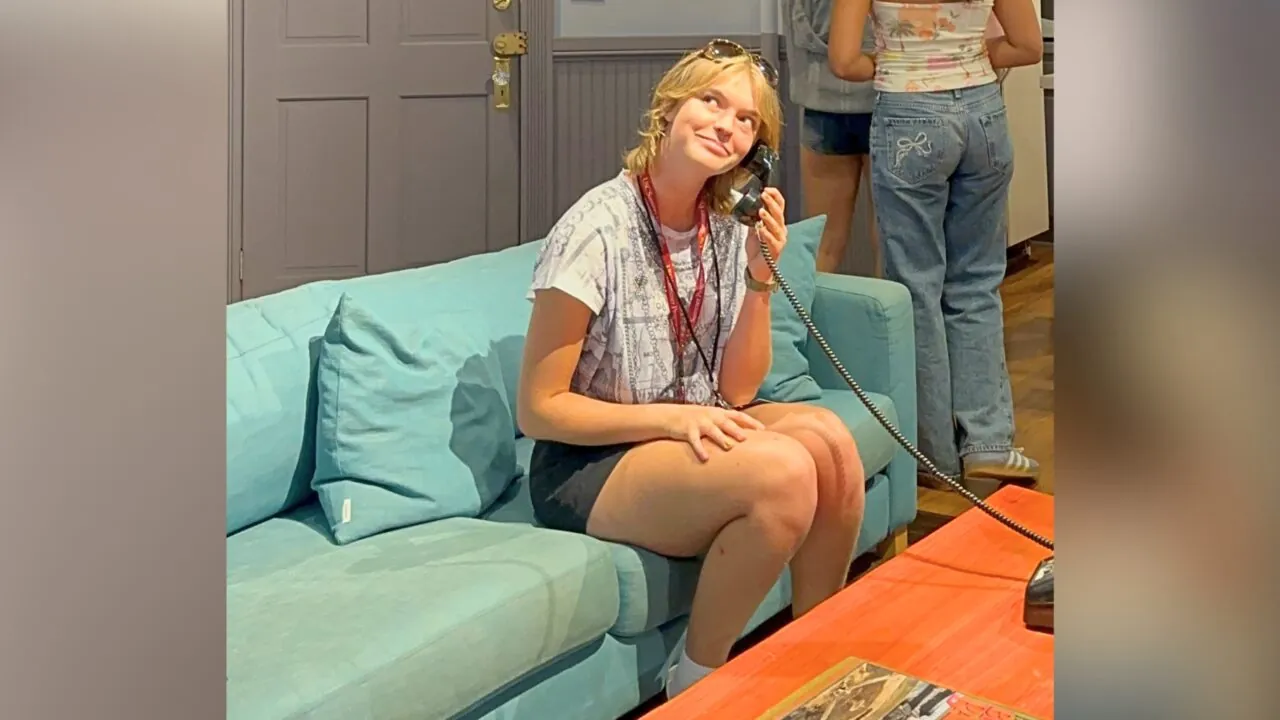 A student pretends to answer the phone in a set at Sony Pictures Studios.