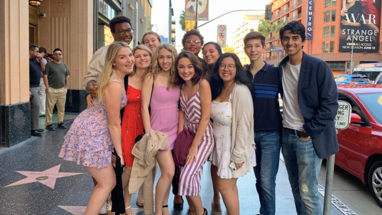 A group of musical theatre students pose on the Hollywood Walk of Fame.