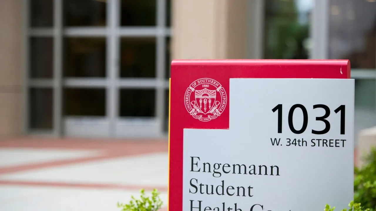 A red and silver campus sign marking the Student Health Center.
