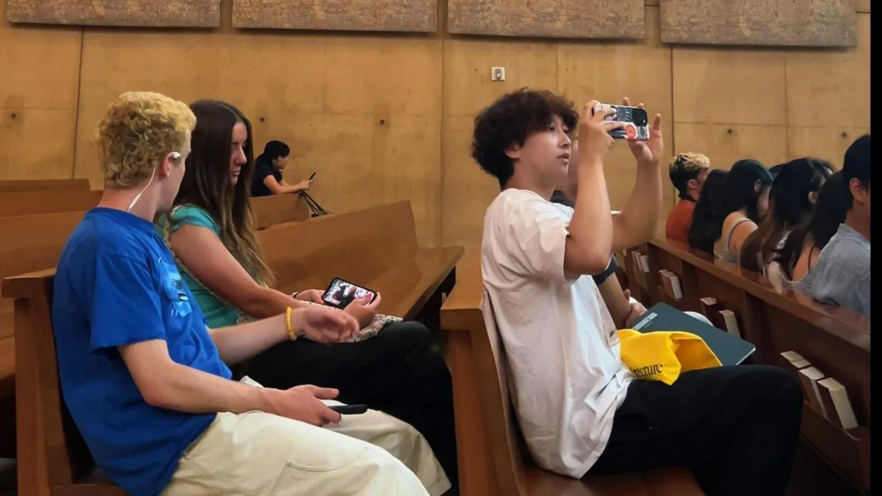 Students sit in the pews of a church during an architecture tour field trip.