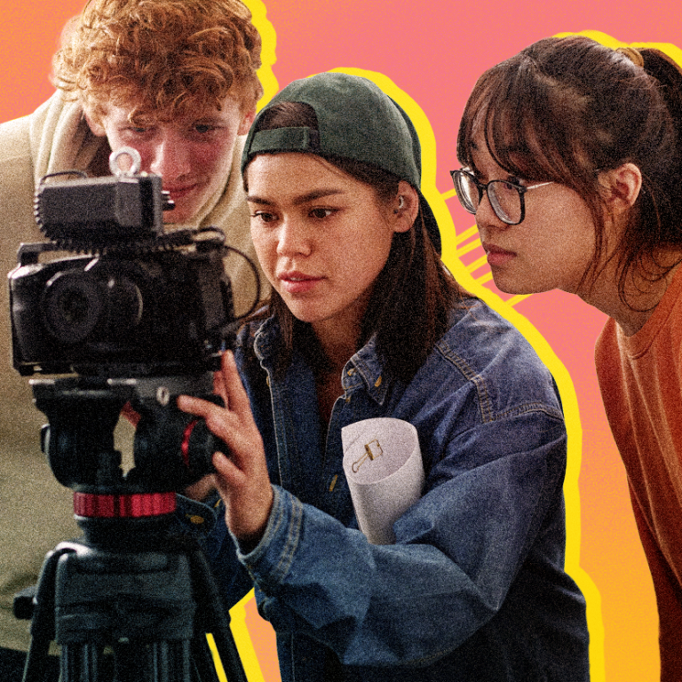 [Graphic] Three young adults gather around a professional video camera mounted on a tripod, with the person in the center wearing a backward baseball cap and denim shirt while adjusting the camera. A pink and orange gradient background features bright yellow outlines around the group and diagonal decorative lines.